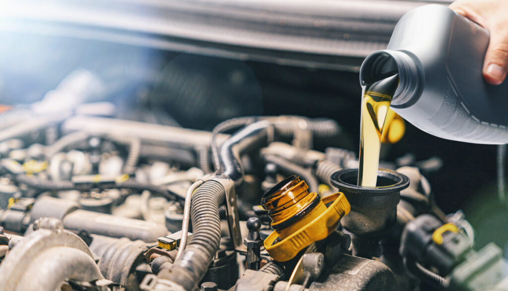 Pouring oil to car engine