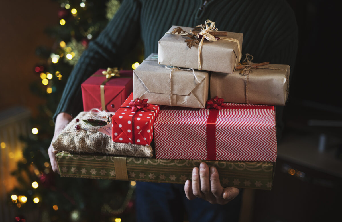 Man Holding Stack With Christmas Presents