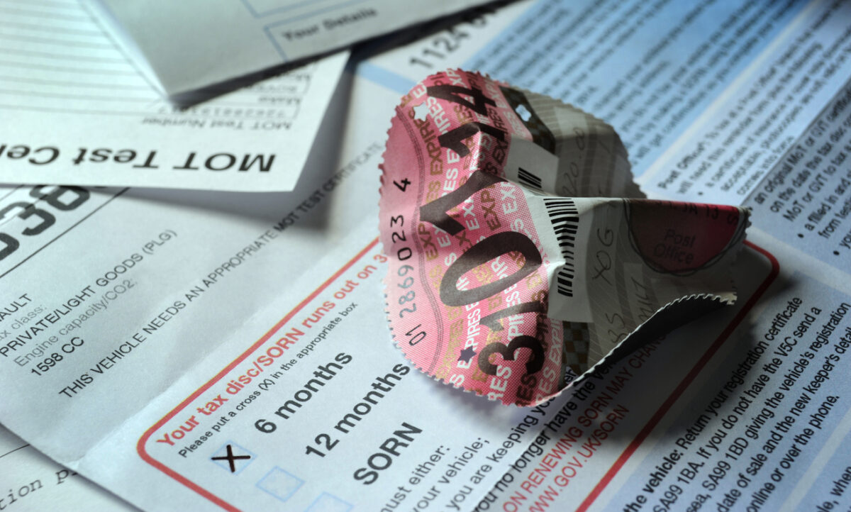 Crumpled British Car Road Tax Disc With Documents