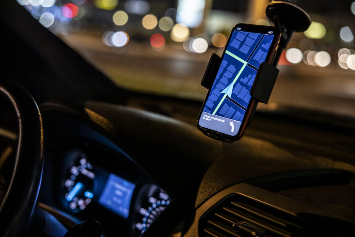 Car Driver with GPS SatNav App At Night