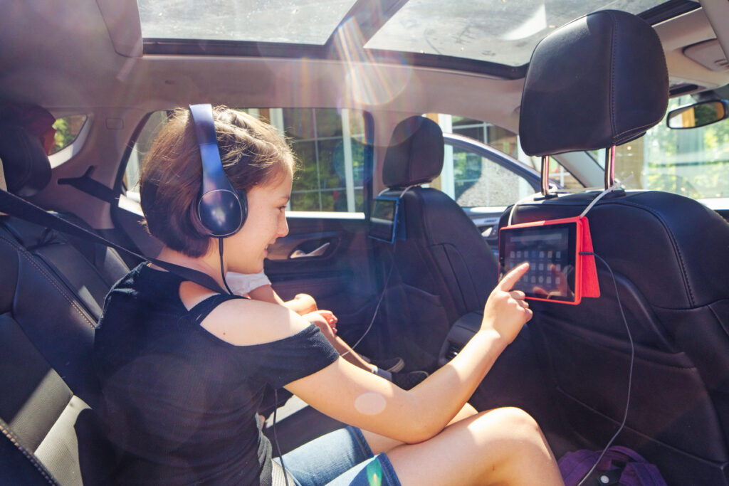 Girl Using Tablet In Car On Roadtrip