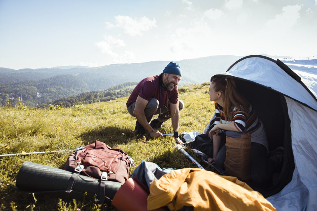 Young couple setting up a tent