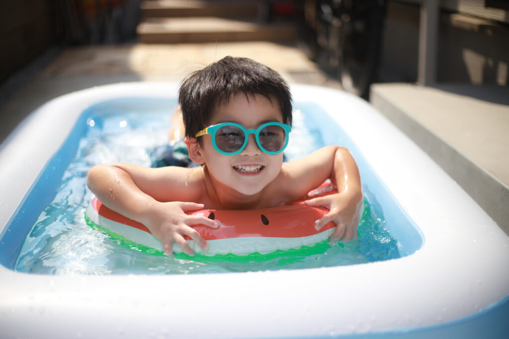 Boy Relaxing in Inflatable Pool