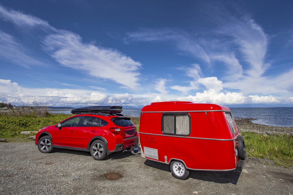 Red Car Towing a Trailer