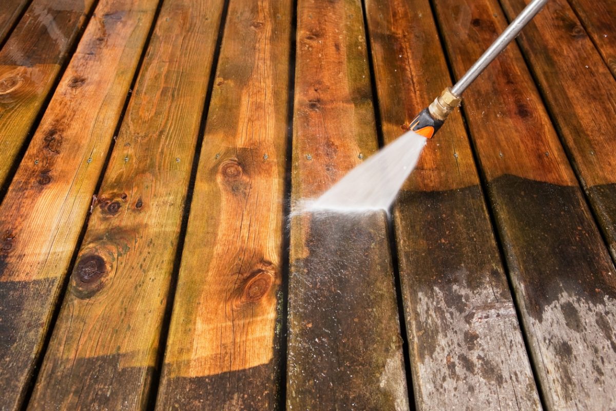 Pressure Washer Cleaning Weathered Deck